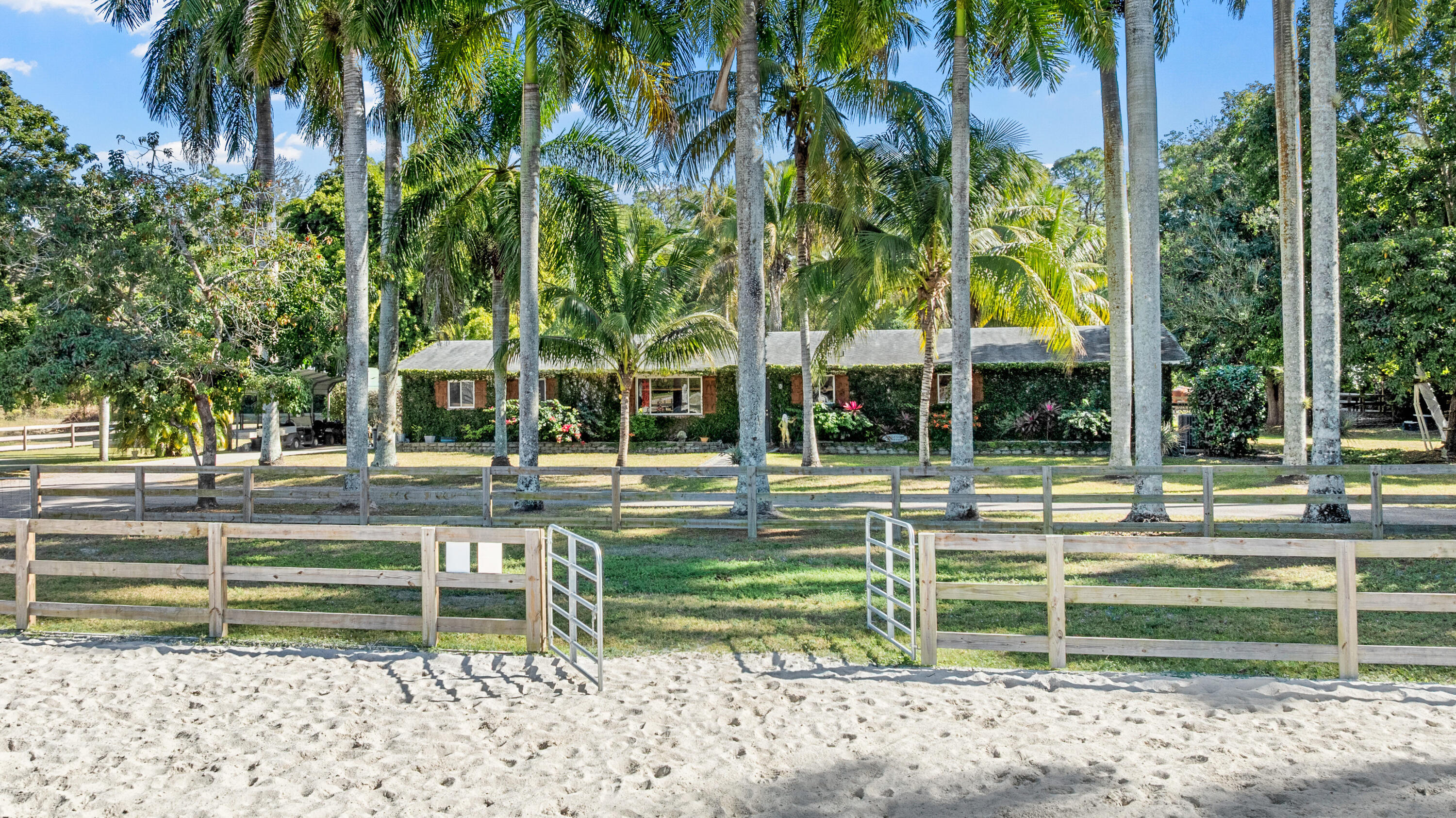 1068 D Road Loxahatchee, FL 33470 - Photo 11 of 73 a view of a house with swimming pool and a big yard