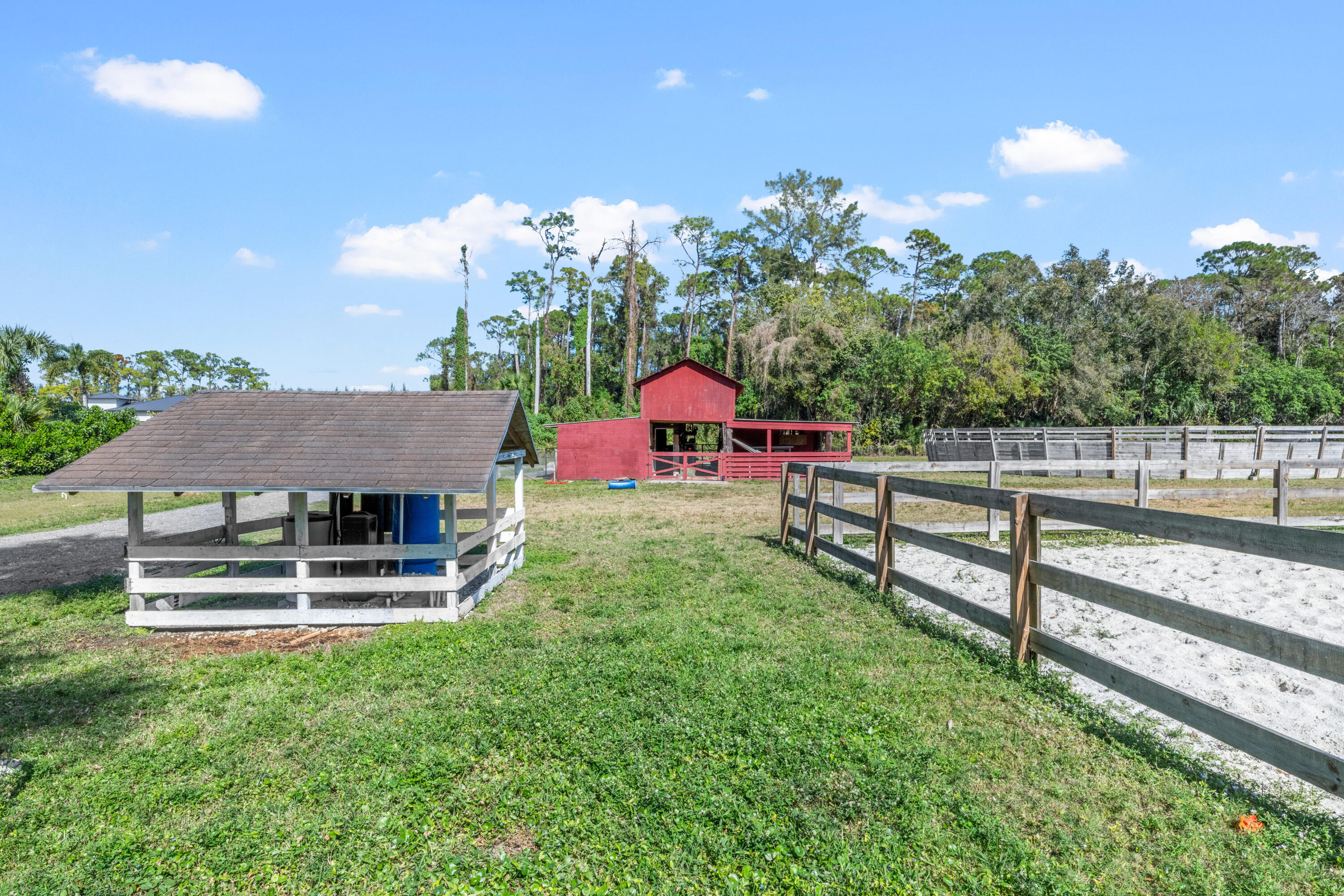 1068 D Road Loxahatchee, FL 33470 - Photo 25 of 73 a view of a house with a yard and sitting area
