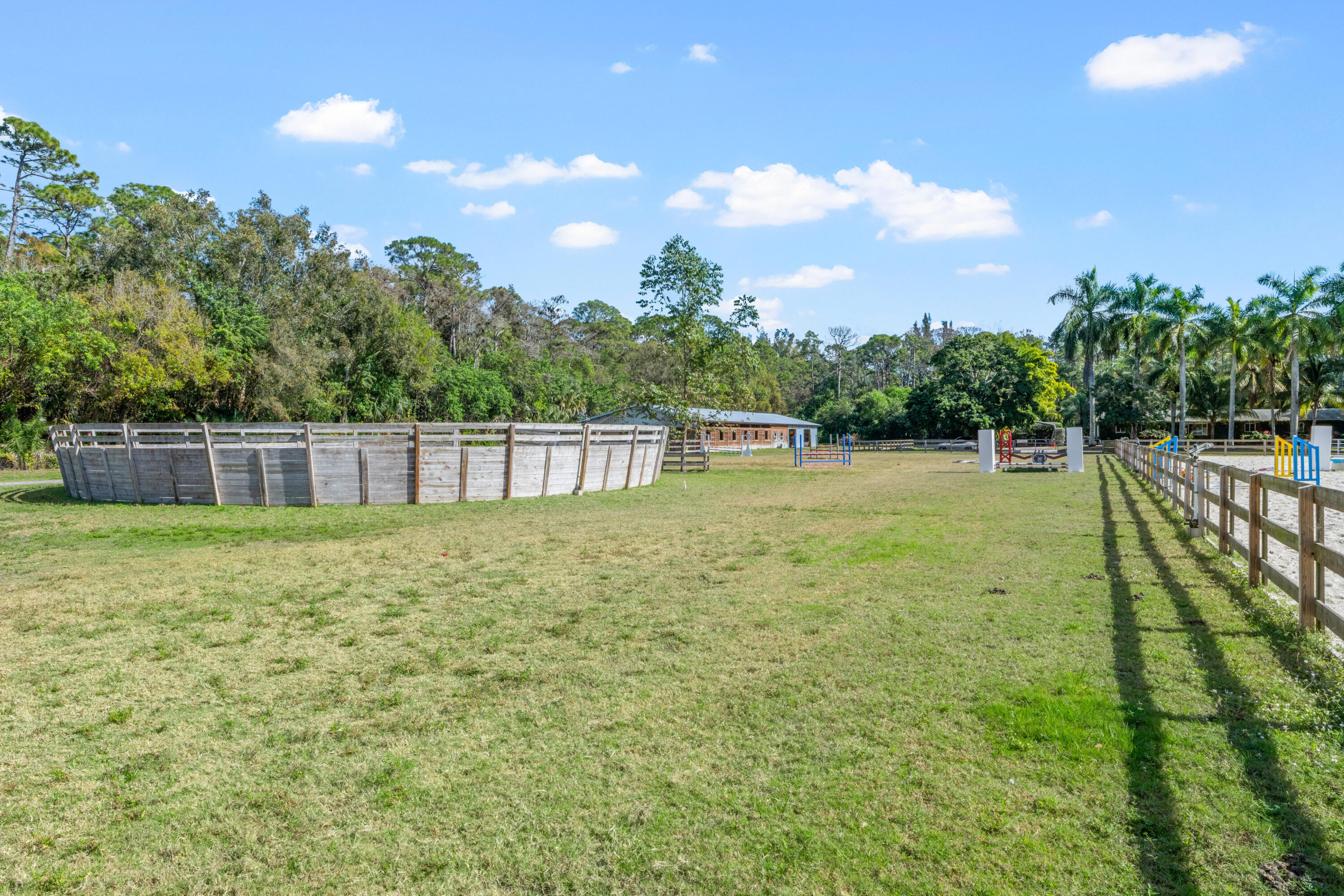 1068 D Road Loxahatchee, FL 33470 - Photo 26 of 73 a view of a garden with a building in the background