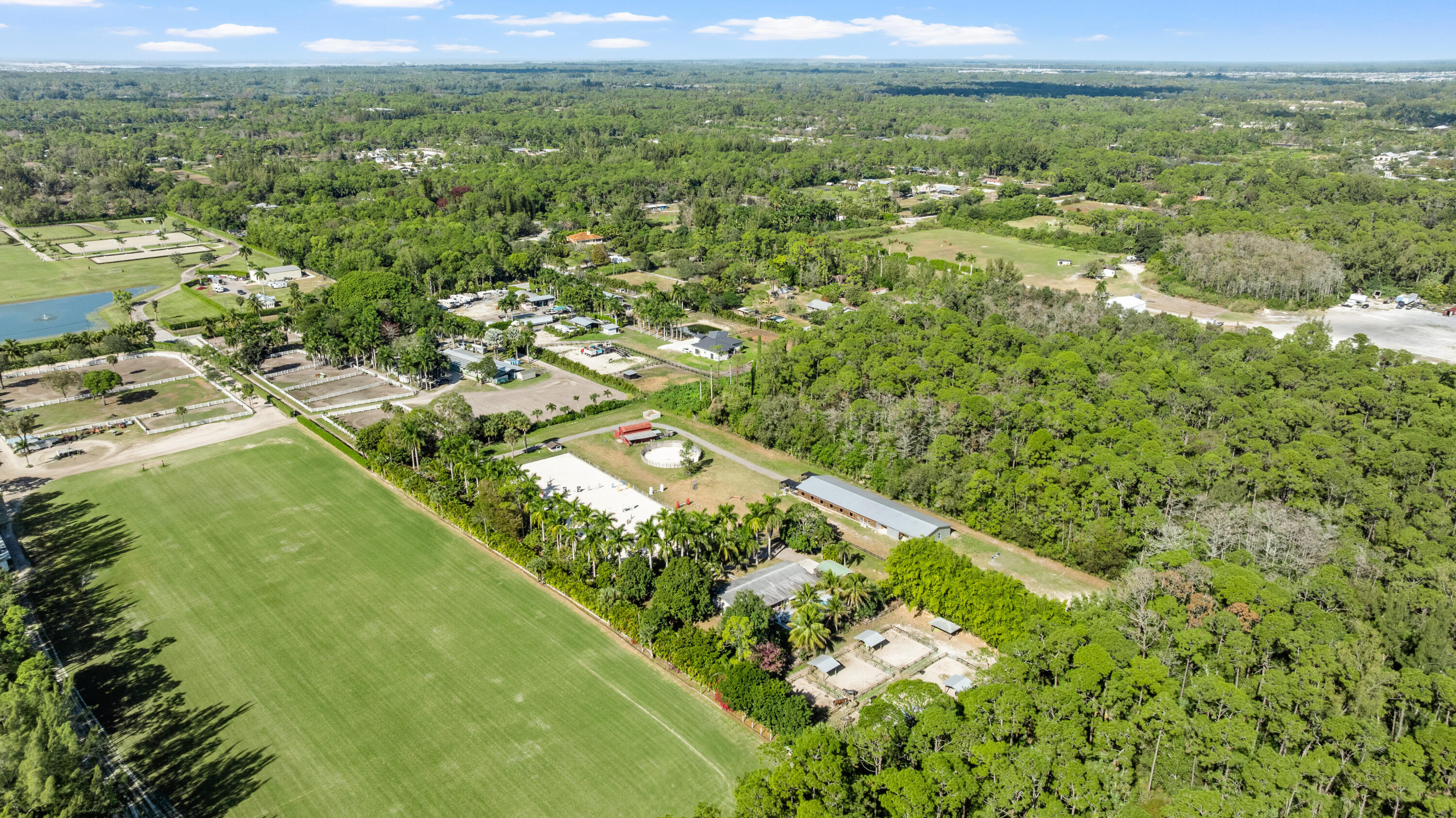 1068 D Road Loxahatchee, FL 33470 - Photo 3 of 73 a view of a city with lush green forest