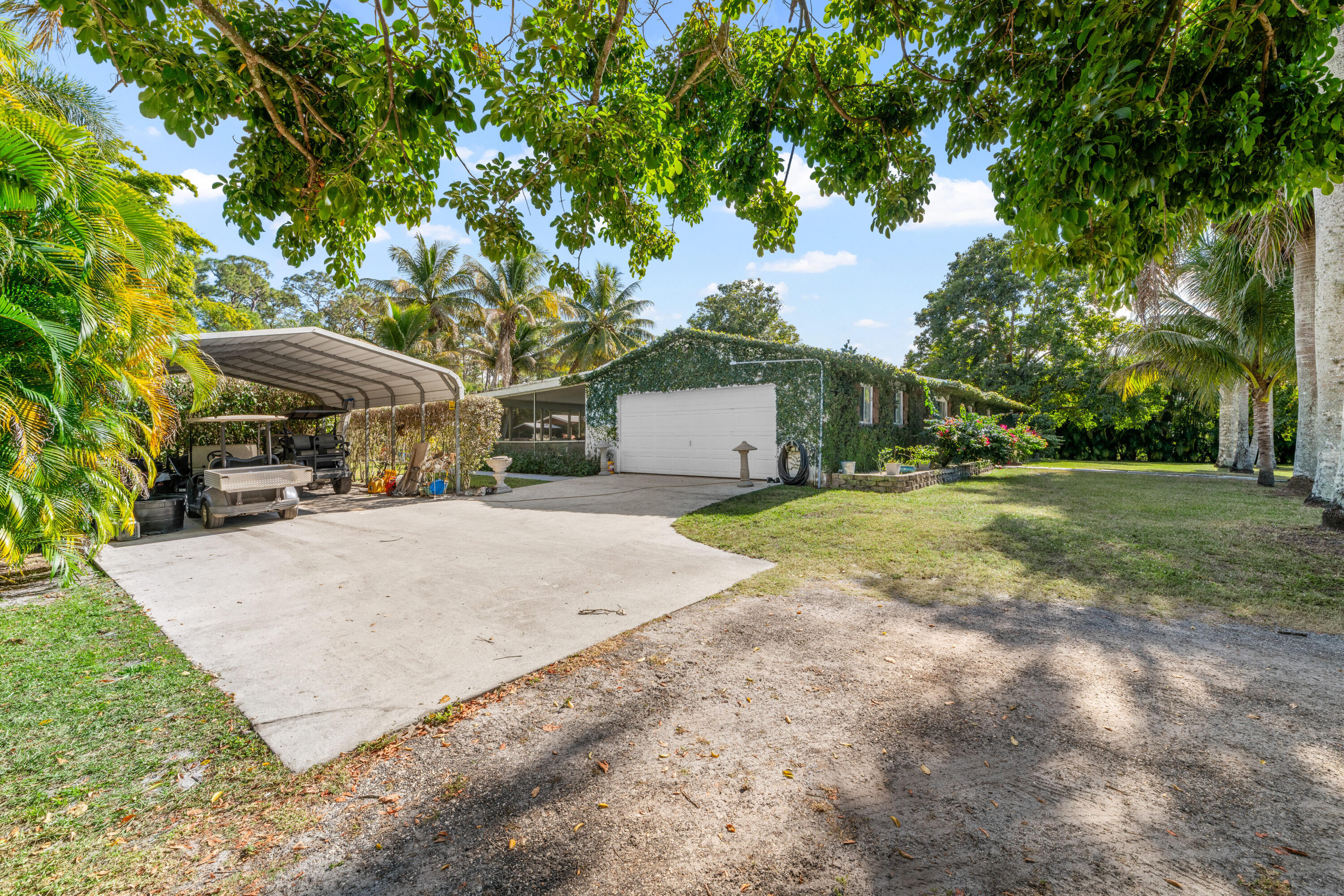 1068 D Road Loxahatchee, FL 33470 - Photo 55 of 73 a view of a house with yard and sitting area