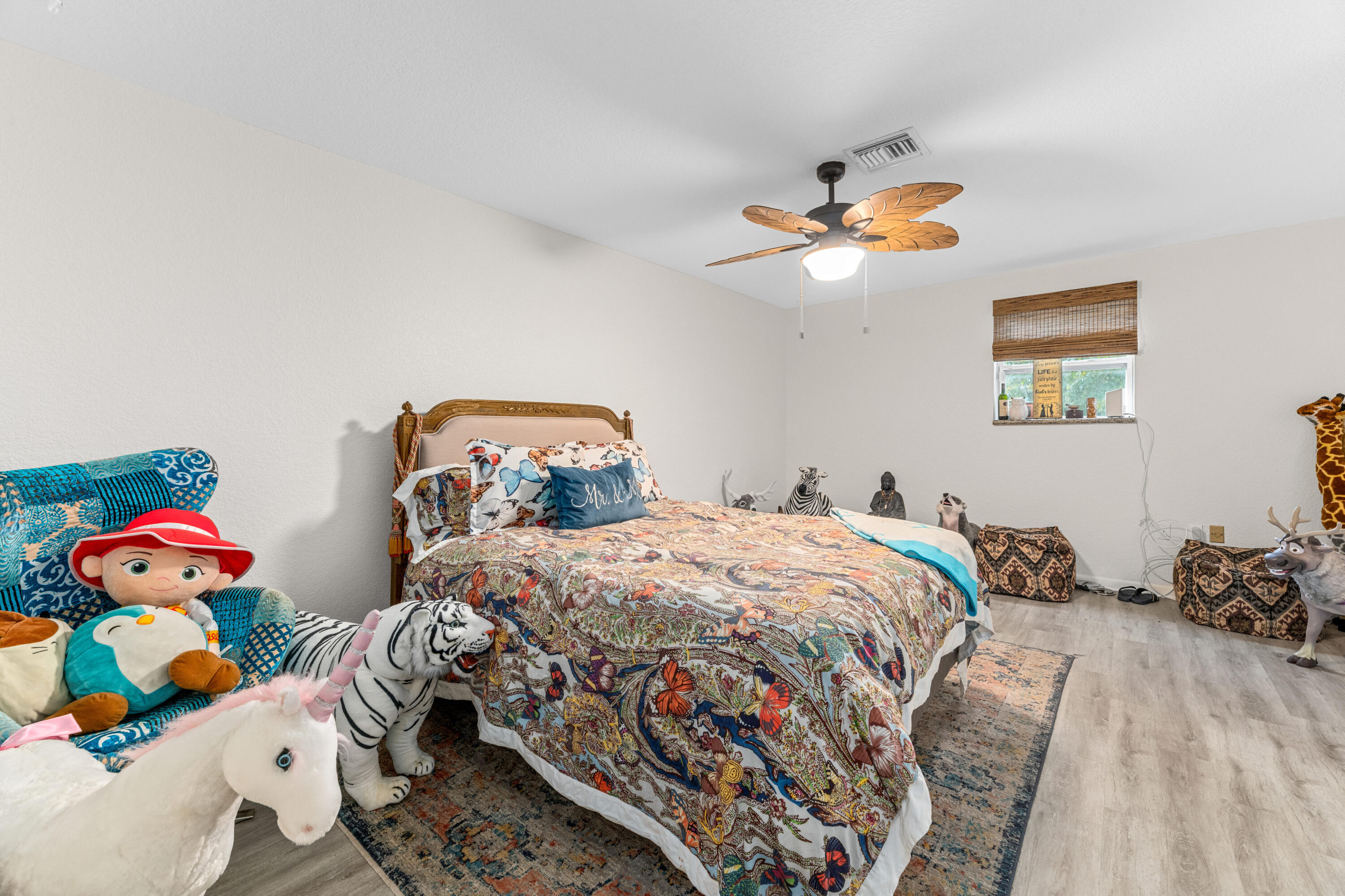 1068 D Road Loxahatchee, FL 33470 - Photo 64 of 73 a bedroom with two beds and a chandelier