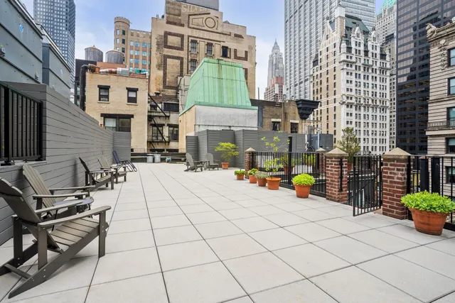 a view of a patio with table and chairs and potted plants