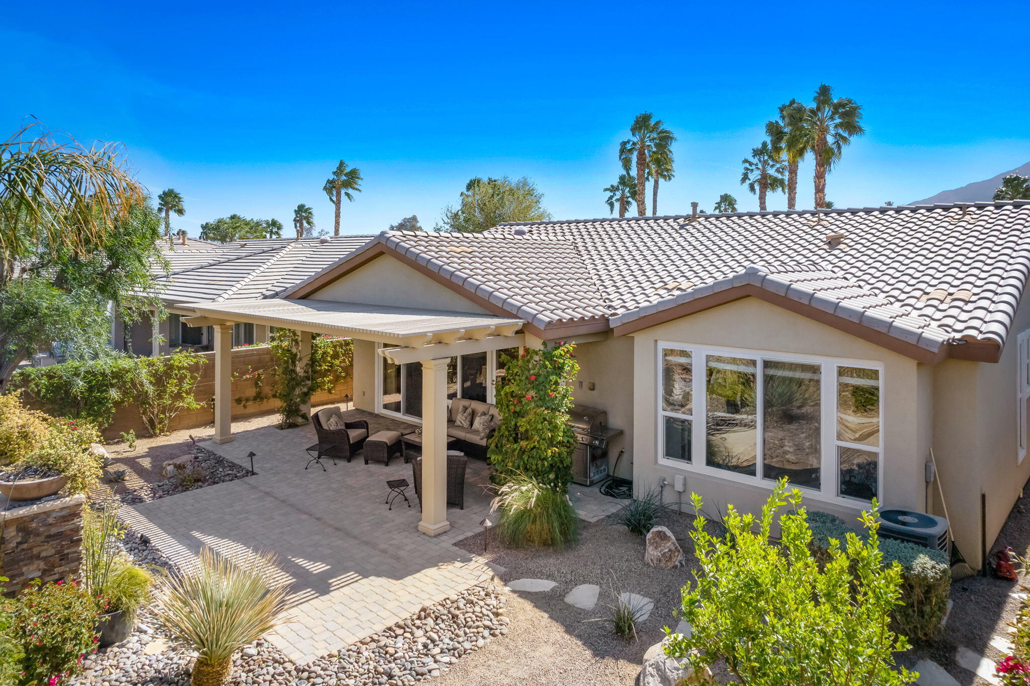 81820 Rustic Canyon Drive La Quinta, CA 92253 - Photo 1 of 85 a view of a patio with table and chairs under an umbrella