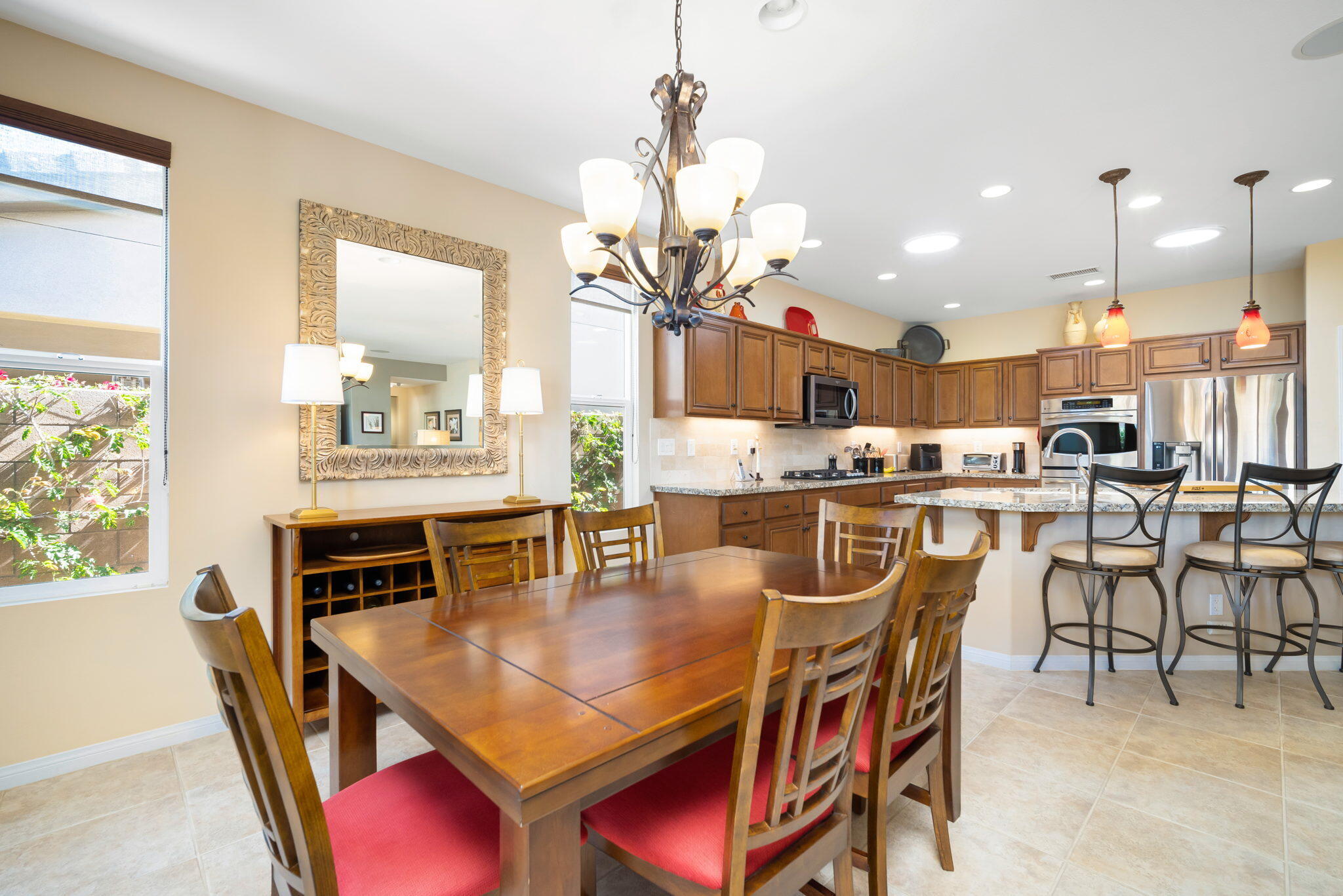 81820 Rustic Canyon Drive La Quinta, CA 92253 - Photo 12 of 85 a dining room with stainless steel appliances kitchen island granite countertop a dining table chairs and granite counter tops