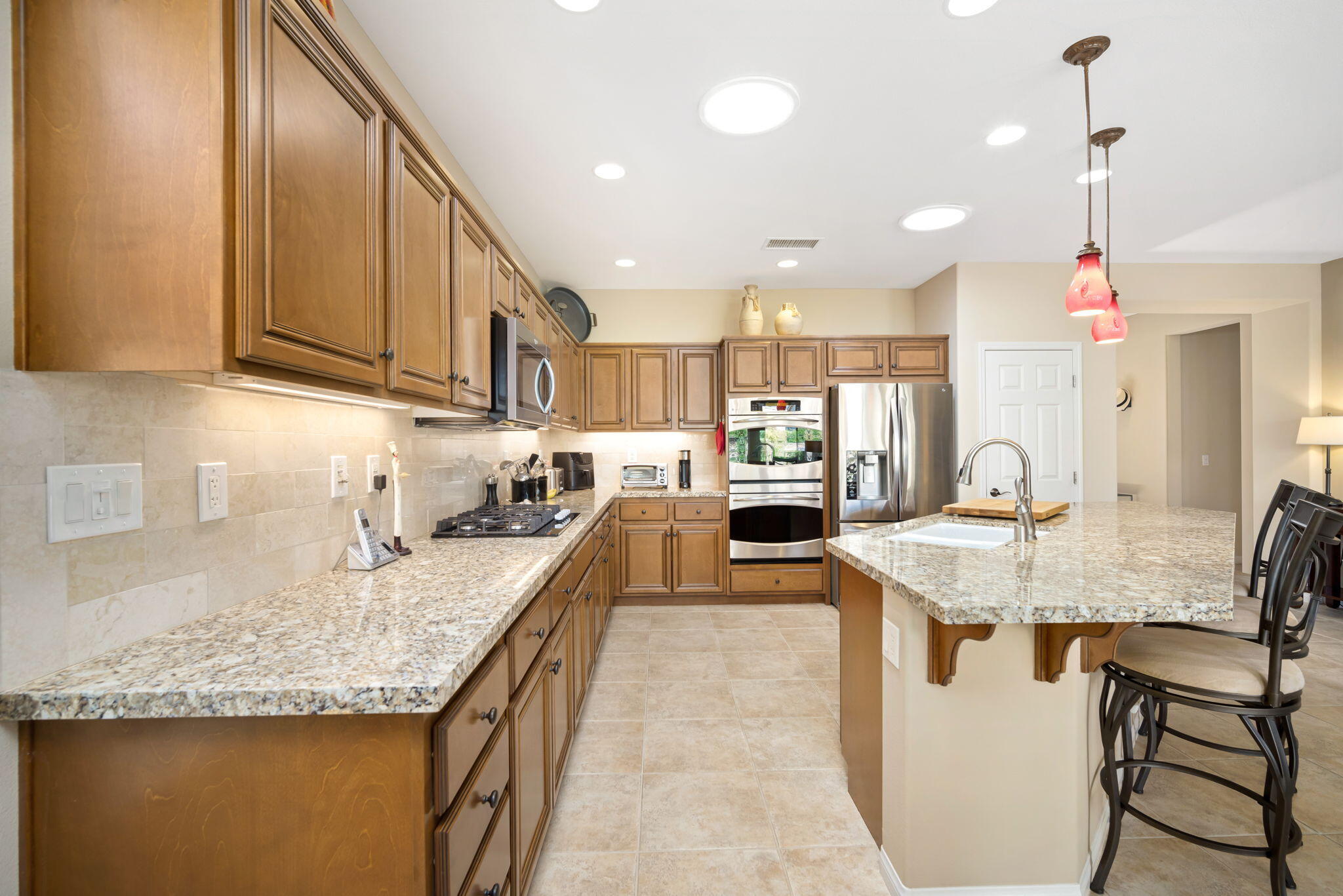 81820 Rustic Canyon Drive La Quinta, CA 92253 - Photo 14 of 85 a kitchen with kitchen island granite countertop a sink and counter space