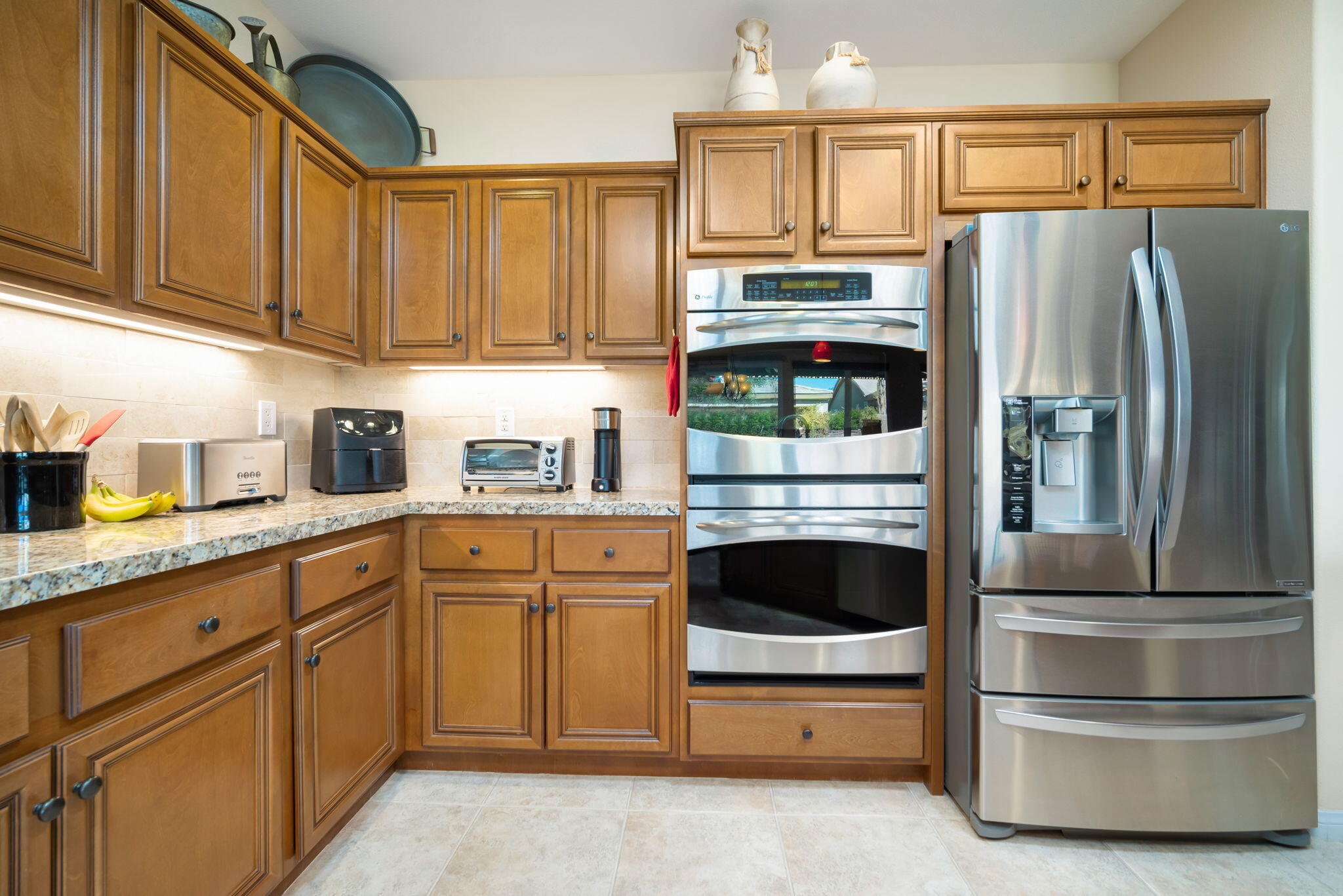81820 Rustic Canyon Drive La Quinta, CA 92253 - Photo 18 of 85 a kitchen with stainless steel appliances granite countertop a refrigerator and cabinets