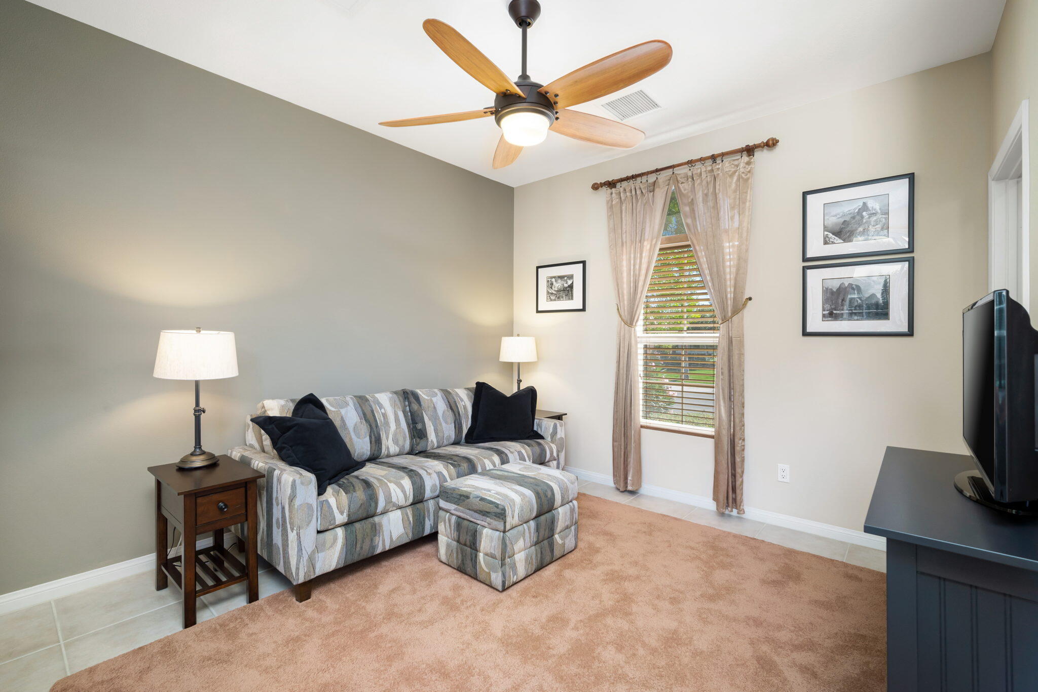 81820 Rustic Canyon Drive La Quinta, CA 92253 - Photo 29 of 85 a living room with furniture a lamp and a flat screen tv