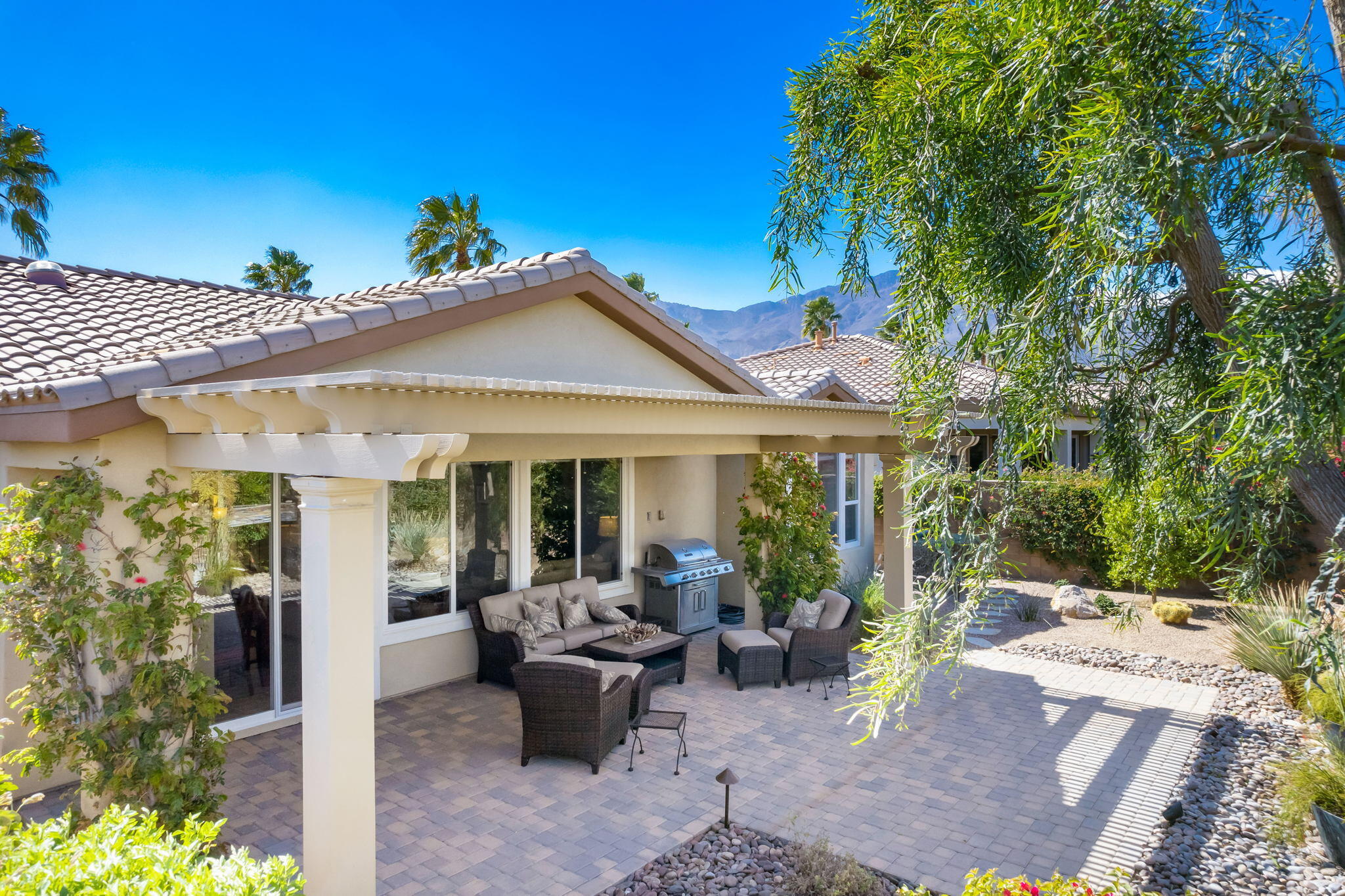 81820 Rustic Canyon Drive La Quinta, CA 92253 - Photo 35 of 85 a view of a house with backyard sitting area and porch