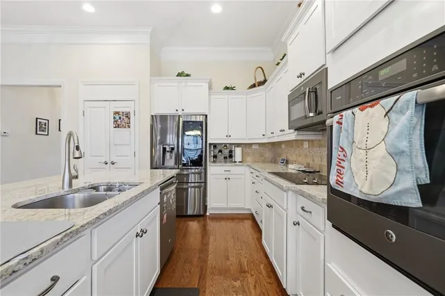 a kitchen with a table chairs and white cabinets