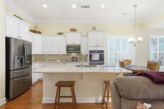 a view of kitchen with livingroom and wooden floor