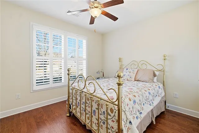 a bedroom with a bed and a flat tv screen on a dresser