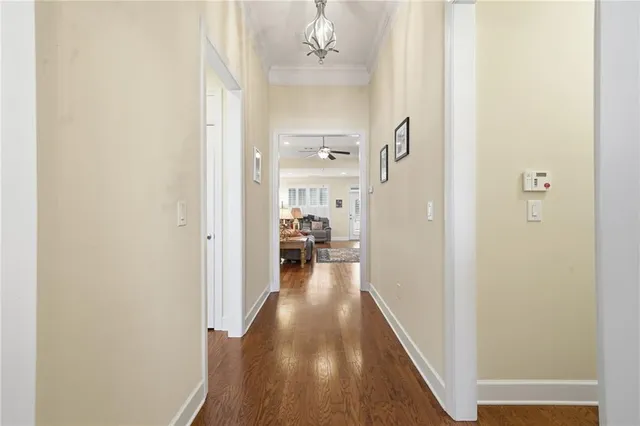 a living room with furniture a flat screen tv and kitchen view
