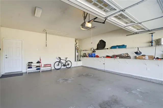 an aerial view of a house with garden space and wooden benches