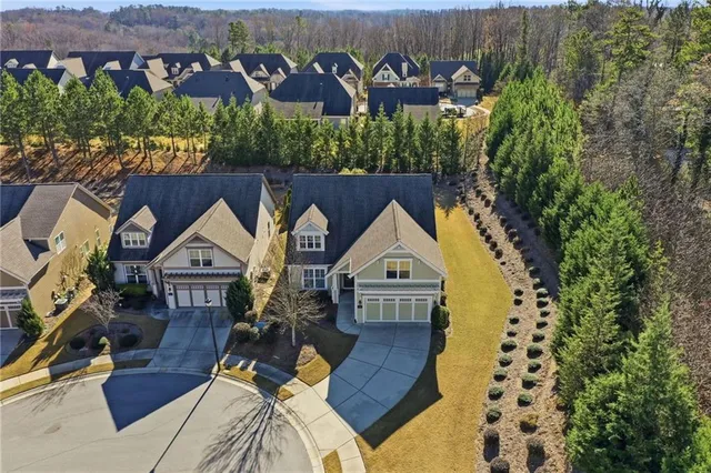 a view of house with backyard and seating area