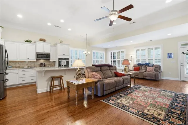 a living room with lots of furniture and wooden floor