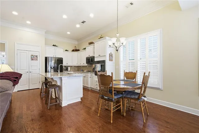 a view of a dining room with furniture wooden floor and chandelier