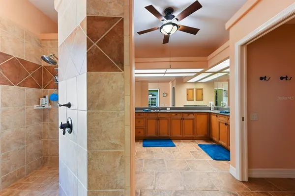 a spacious bathroom with a granite countertop sink and a mirror
