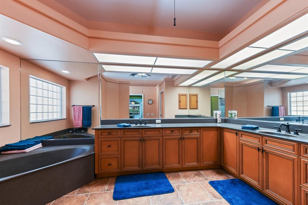 4911 Linkside Drive Punta Gorda, FL 33955 - Photo 32 of 64 a kitchen with stainless steel appliances granite countertop a sink stove and wooden cabinets