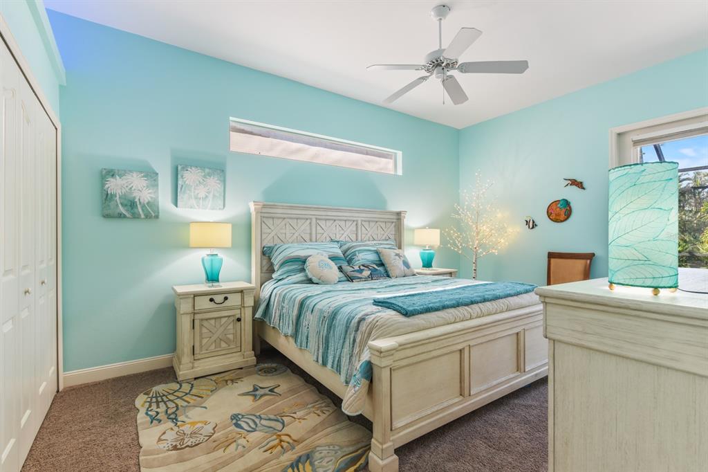 4911 Linkside Drive Punta Gorda, FL 33955 - Photo 33 of 64 a bedroom with a bed and a chandelier