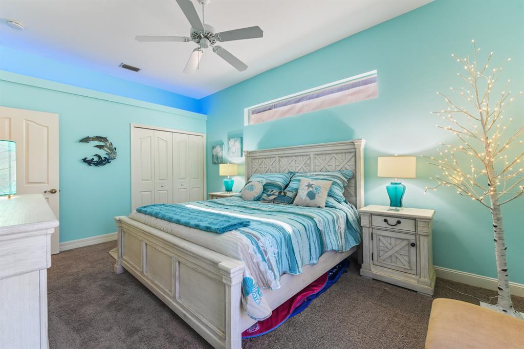 4911 Linkside Drive Punta Gorda, FL 33955 - Photo 34 of 64 a bedroom with a bed and a chandelier