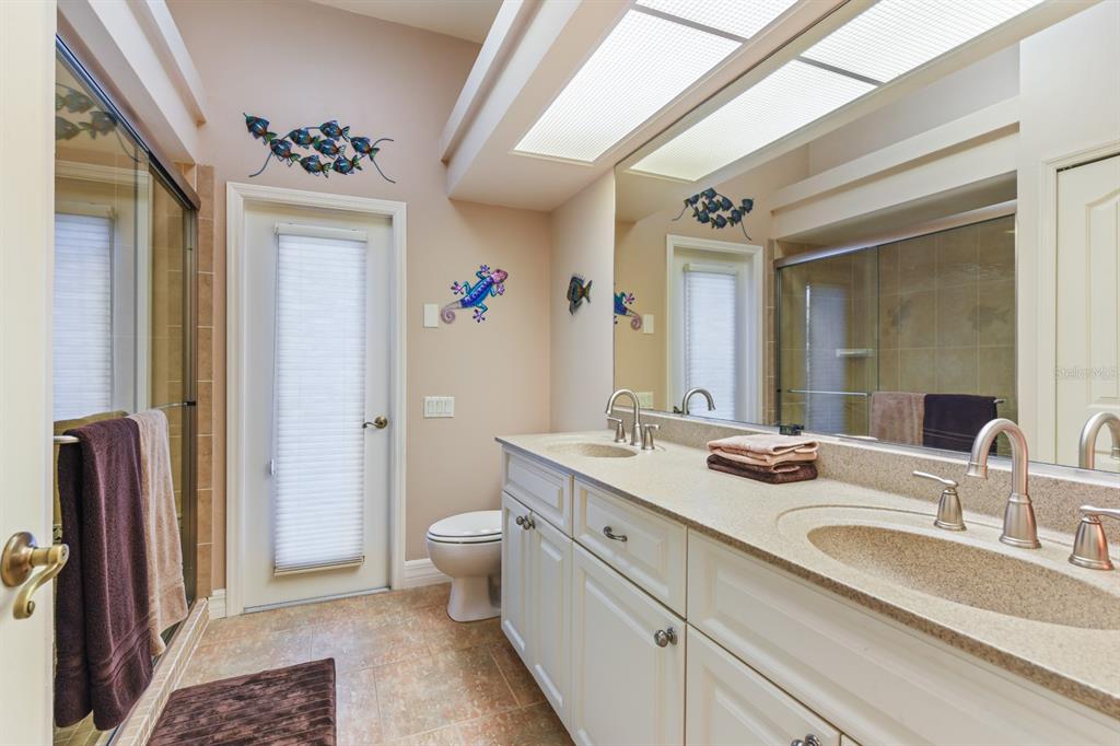 4911 Linkside Drive Punta Gorda, FL 33955 - Photo 35 of 64 a spacious bathroom with a granite countertop sink and a mirror