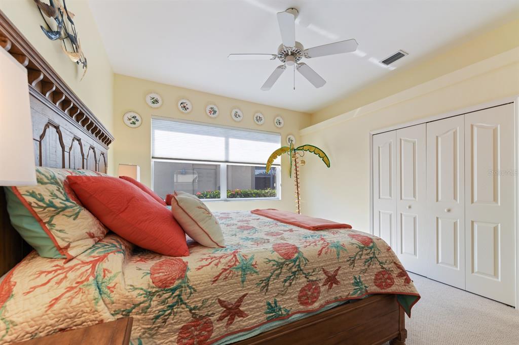 4911 Linkside Drive Punta Gorda, FL 33955 - Photo 37 of 64 a bedroom with a bed next to a large window