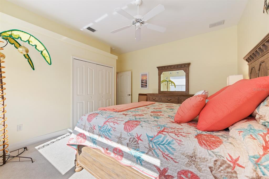 4911 Linkside Drive Punta Gorda, FL 33955 - Photo 38 of 64 a bedroom with a bed and a chandelier