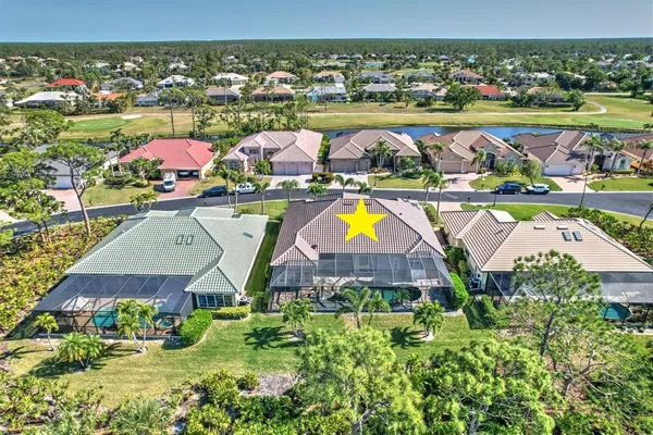a view of a patio with a table and chairs under an umbrella with a small yard
