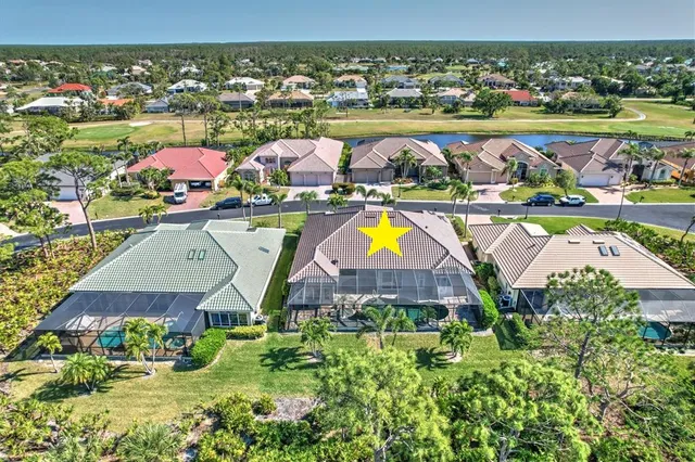 an aerial view of residential houses with outdoor space and swimming pool