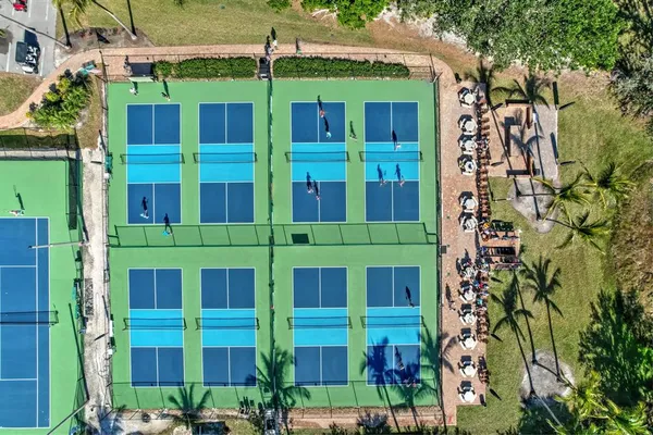an aerial view of residential houses with outdoor space and swimming pool