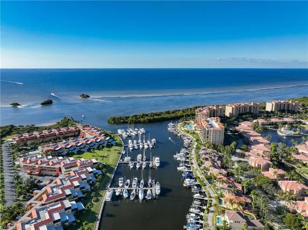an aerial view of house with yard and mountain view in back