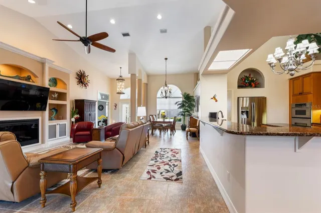 a living room with patio furniture and a large window