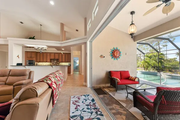 a living room with furniture a rug and a chandelier