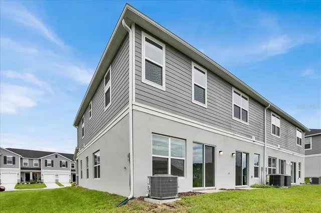 a front view of residential houses with yard