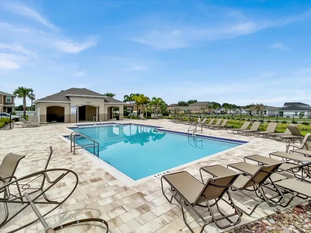 a view of swimming pool with outdoor seating and plants