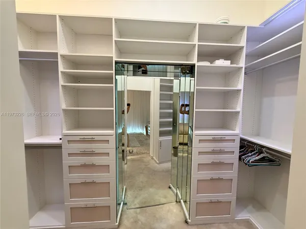 a view of walk in closet with empty racks