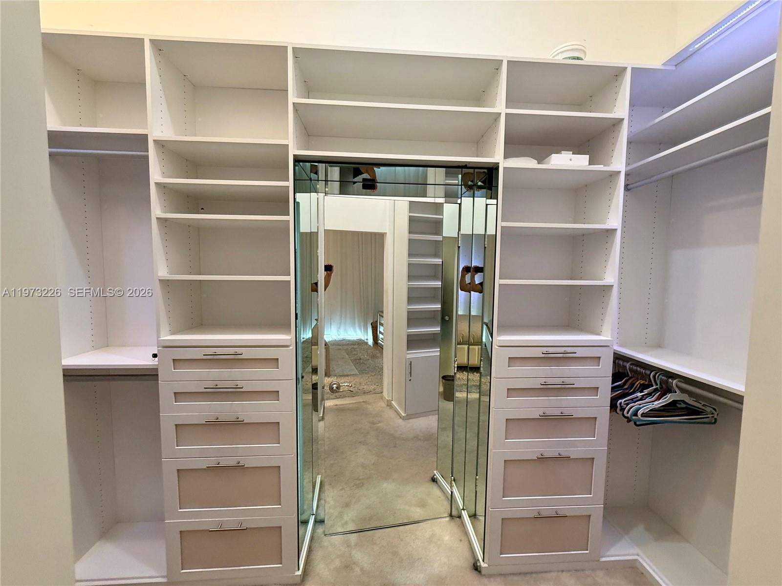 495 Brickell Avenue, Unit 1403 Miami, FL 33131 - Photo 11 of 48 a view of walk in closet with empty racks
