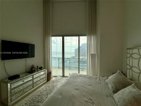 a bed room with a bed and a television