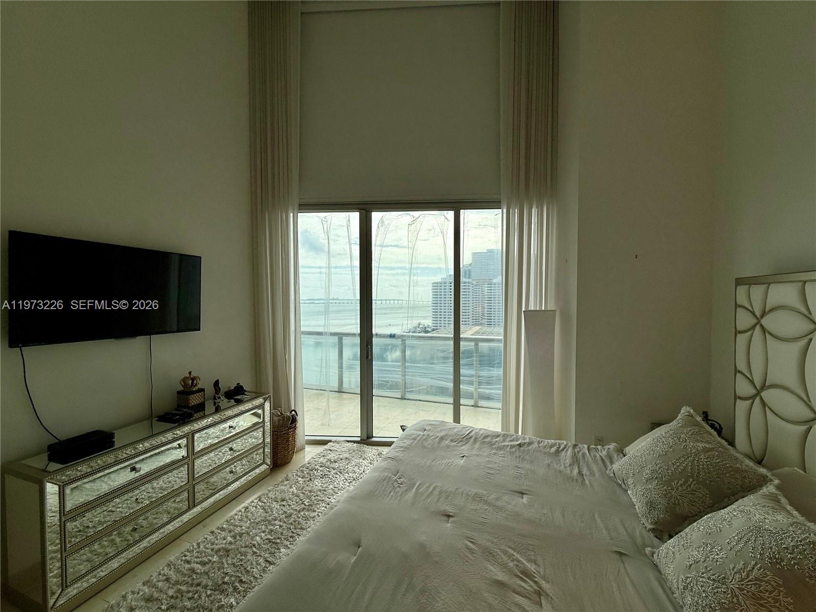 495 Brickell Avenue, Unit 1403 Miami, FL 33131 - Photo 15 of 48 a bed room with a bed and a television