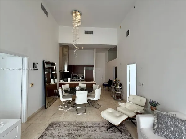 a living room with furniture a fireplace and a table