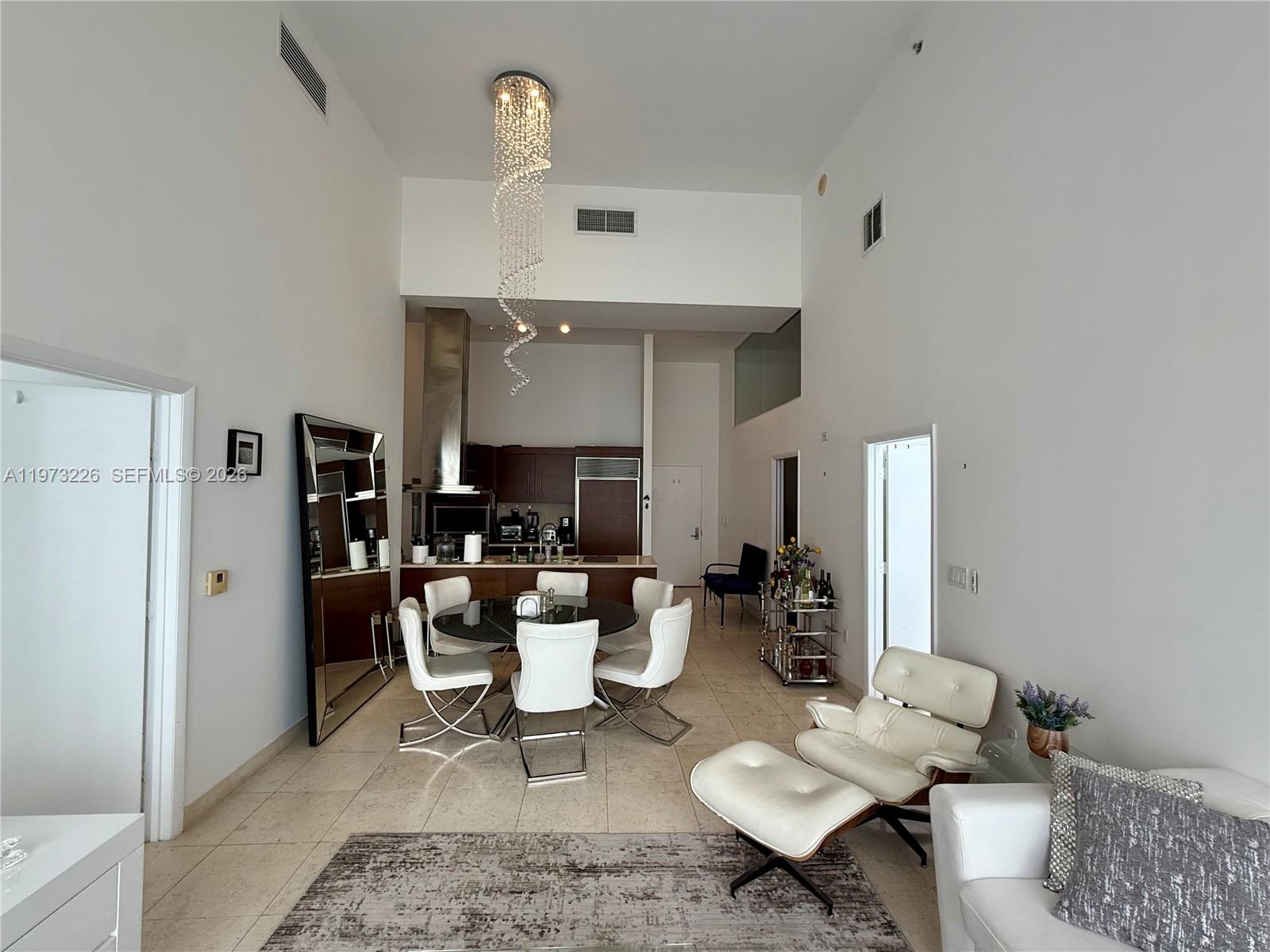 495 Brickell Avenue, Unit 1403 Miami, FL 33131 - Photo 19 of 48 a living room with furniture a fireplace and a table