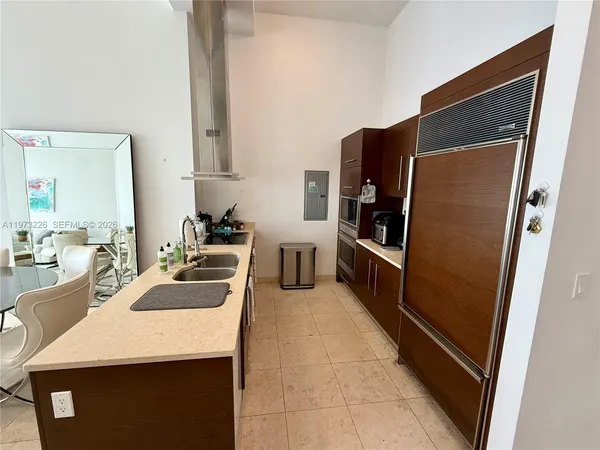 a kitchen with refrigerator and stove