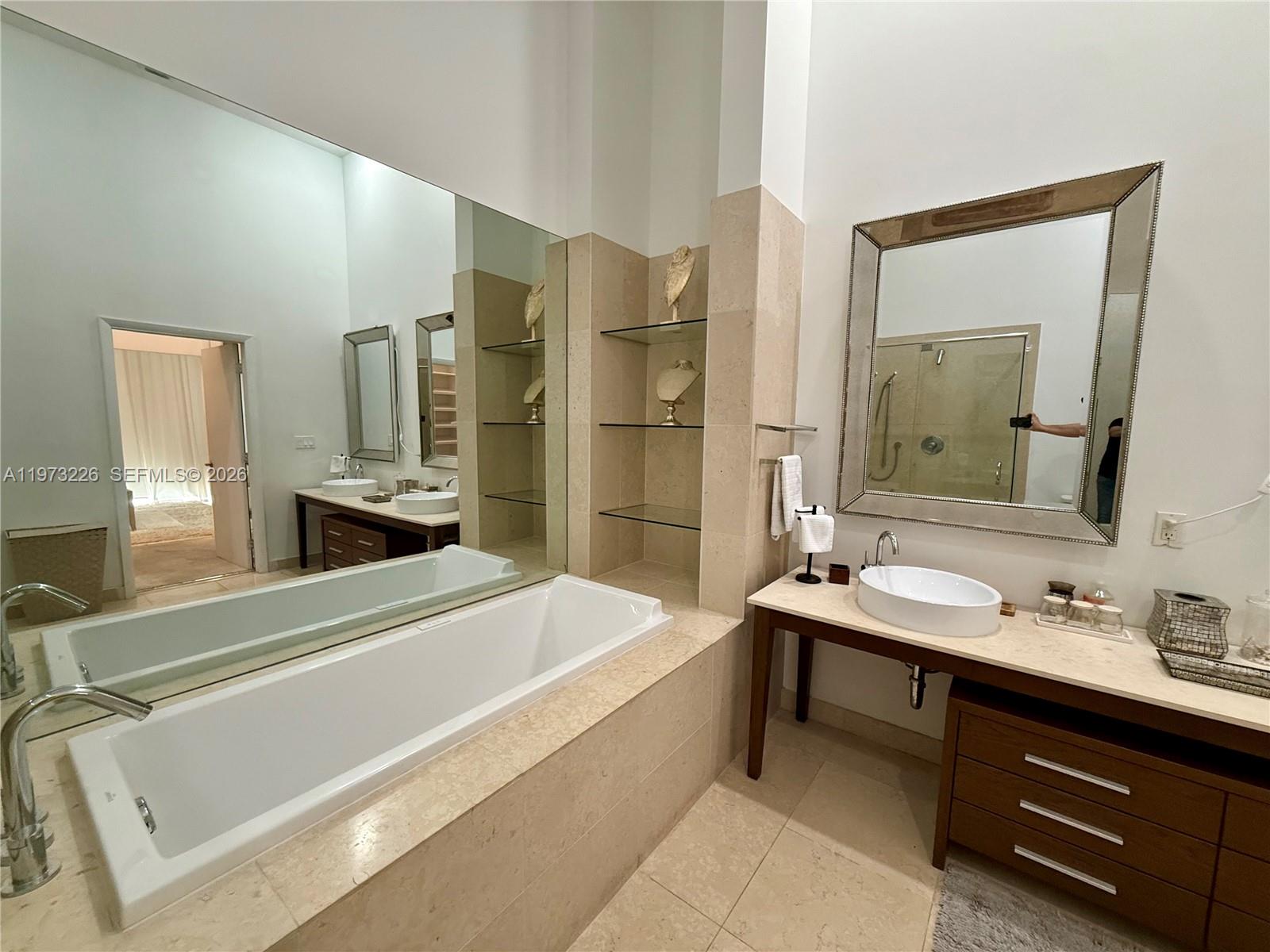 495 Brickell Avenue, Unit 1403 Miami, FL 33131 - Photo 2 of 48 a bathroom with a tub sink and mirror