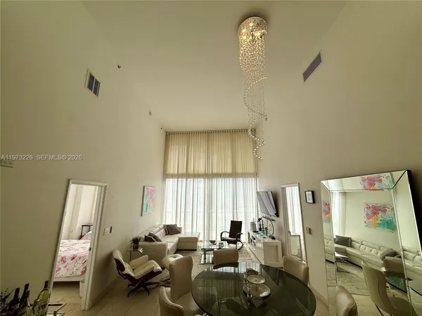 a living room with furniture and a large window