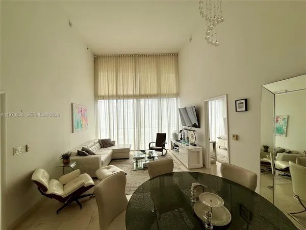 a living room with furniture and a large window