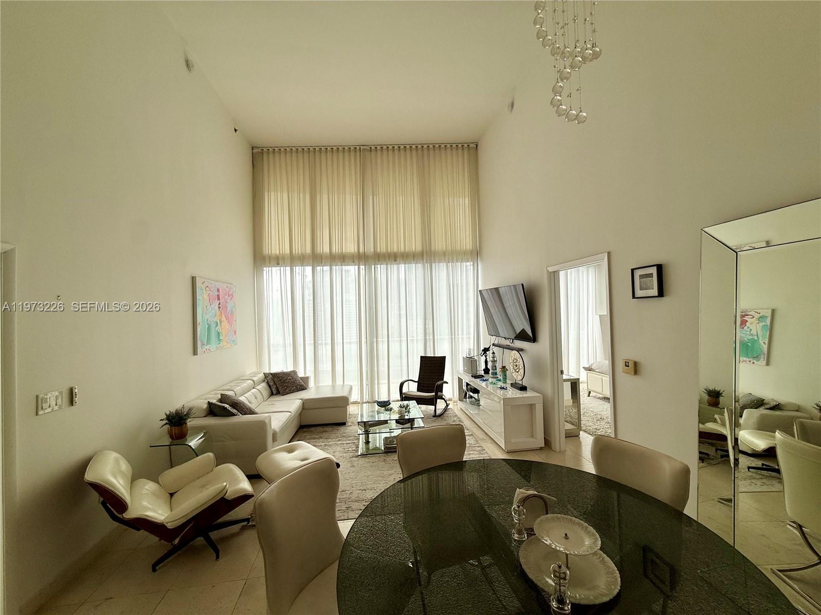 495 Brickell Avenue, Unit 1403 Miami, FL 33131 - Photo 27 of 48 a living room with furniture and a large window