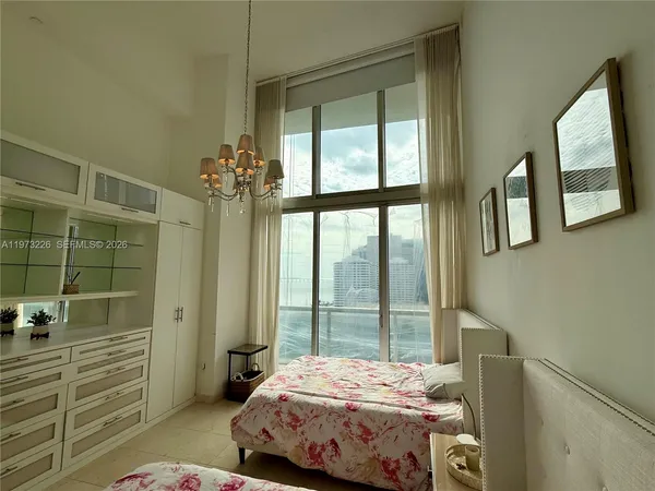 a bedroom with a bed and a mirror