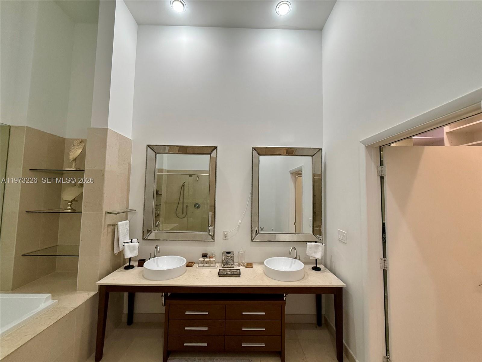 495 Brickell Avenue, Unit 1403 Miami, FL 33131 - Photo 3 of 48 a bathroom with a sink and a mirror