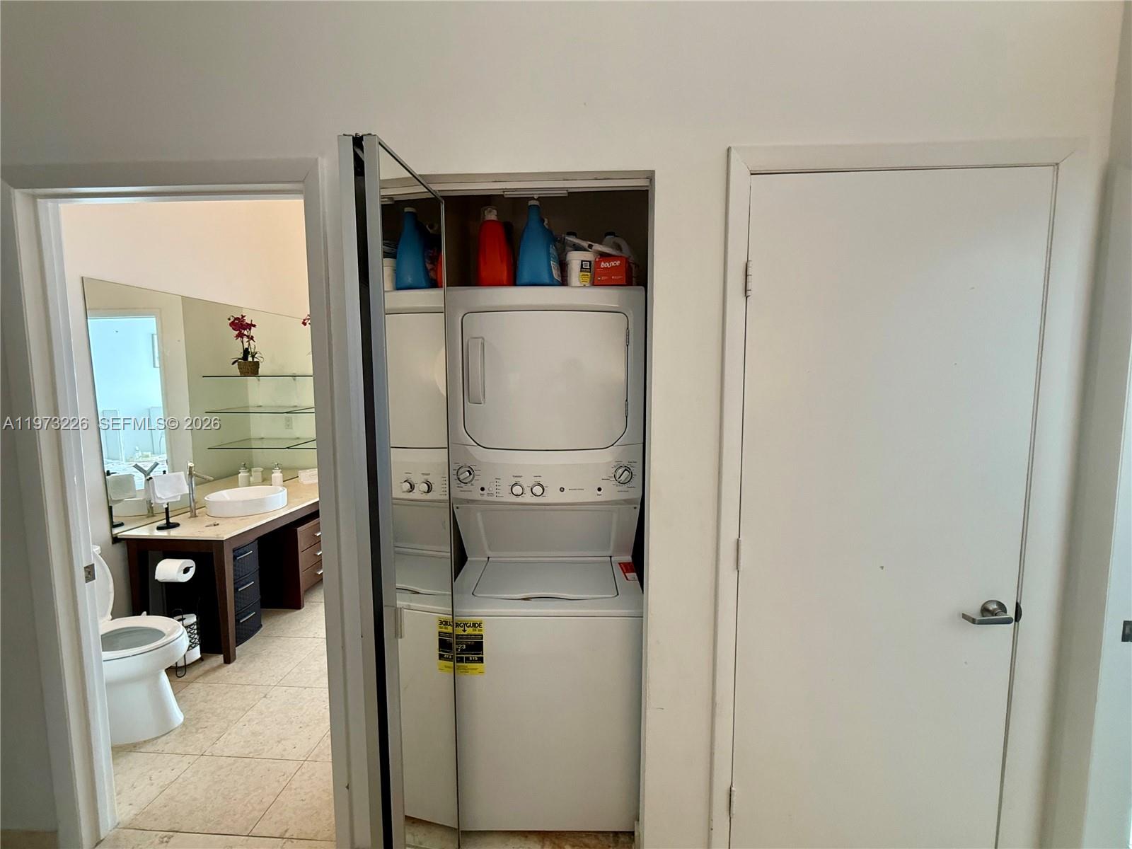495 Brickell Avenue, Unit 1403 Miami, FL 33131 - Photo 35 of 48 a room with a washer and dryer